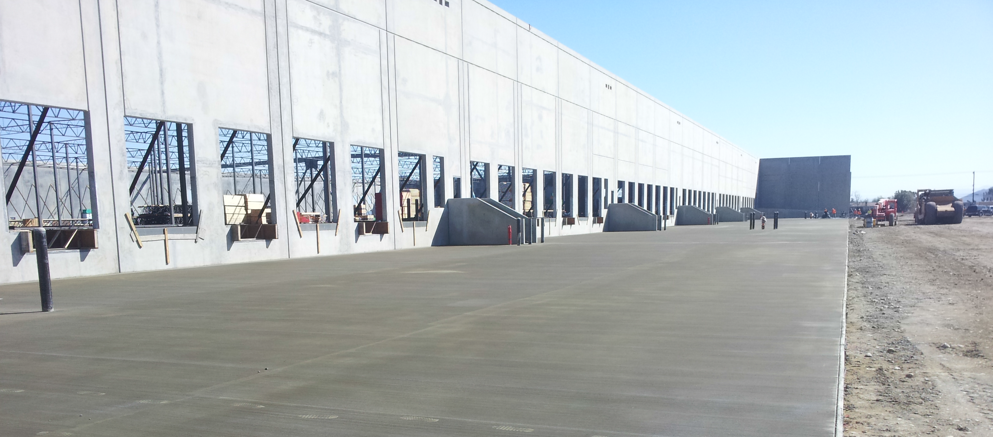 A large warehouse with many windows and doors.
